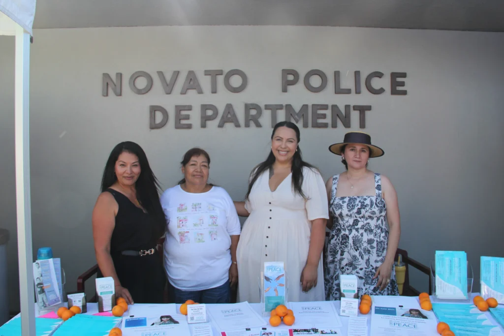 C4DP advocates stand behind an information table outside the Novato Police Department to share domestic-violence resources with the community.
