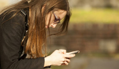 teen female texting on phone